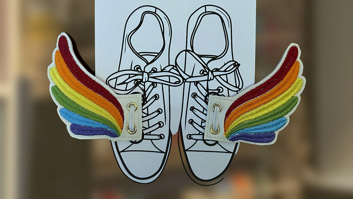 Embroidered rainbow shoe wings laced onto sneakers, handmade in Louisville, KY
