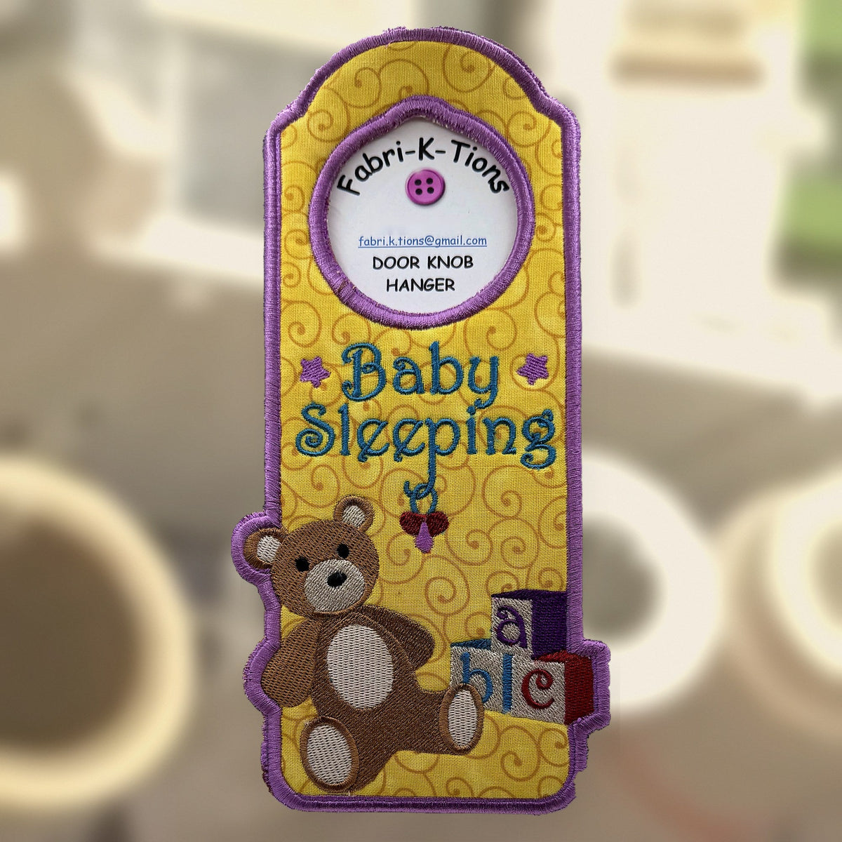 Baby Sleeping Door Knob Hanger, an embroidered fabric door hanger, handmade in Louisville, KY