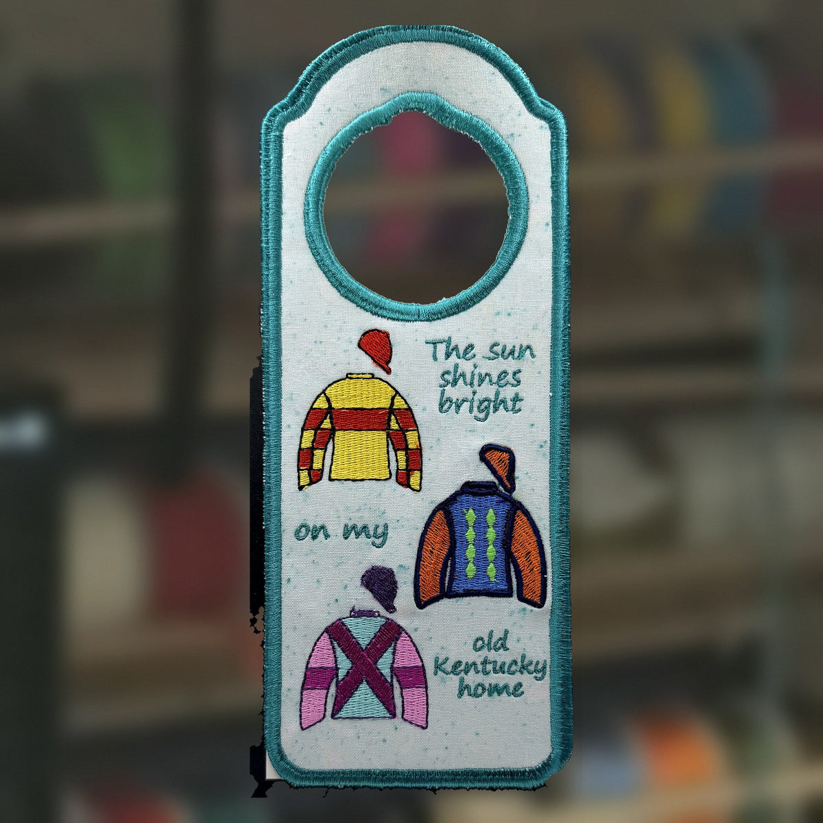 Derby Silks Door Knob Hanger, an embroidered fabric door hanger, handmade in Louisville, KY
