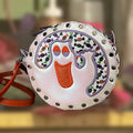 Ghost Round Rivet Bag with an embroidered ghost, candy print and orange strap, handmade in Louisville, KY