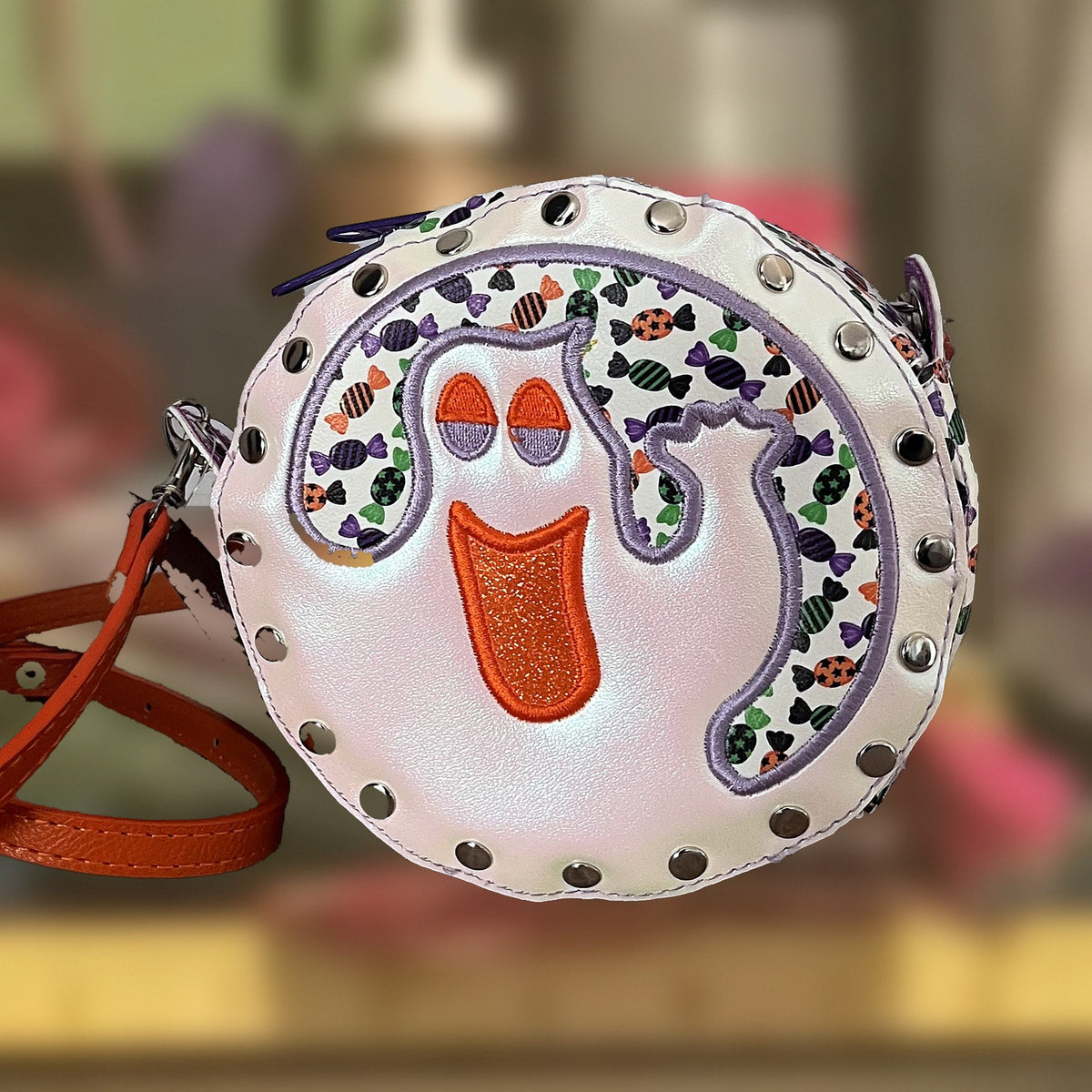 Ghost Round Rivet Bag with an embroidered ghost, candy print and orange strap, handmade in Louisville, KY