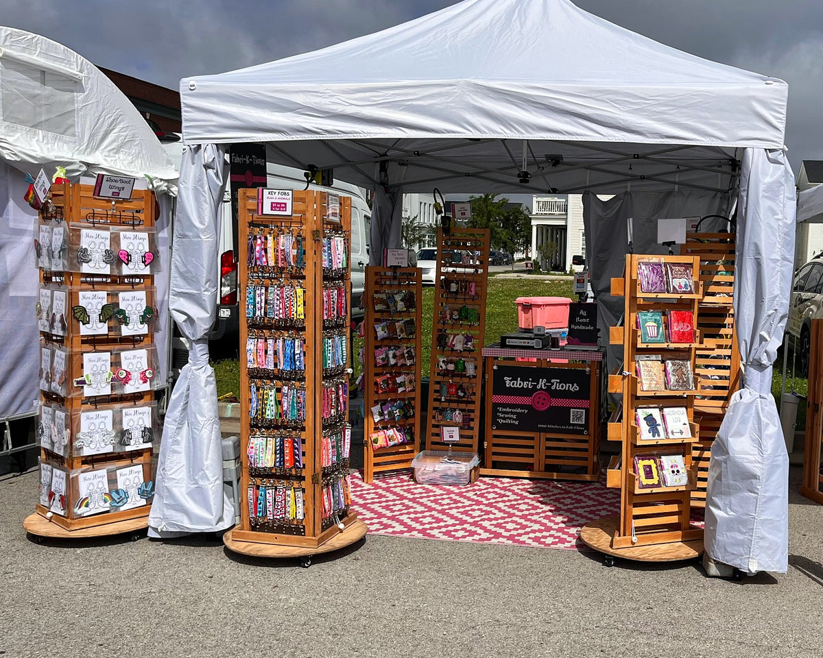 Fabri-K-Tions festival tent with wooden racks of handmade notebooks, bags and gifts