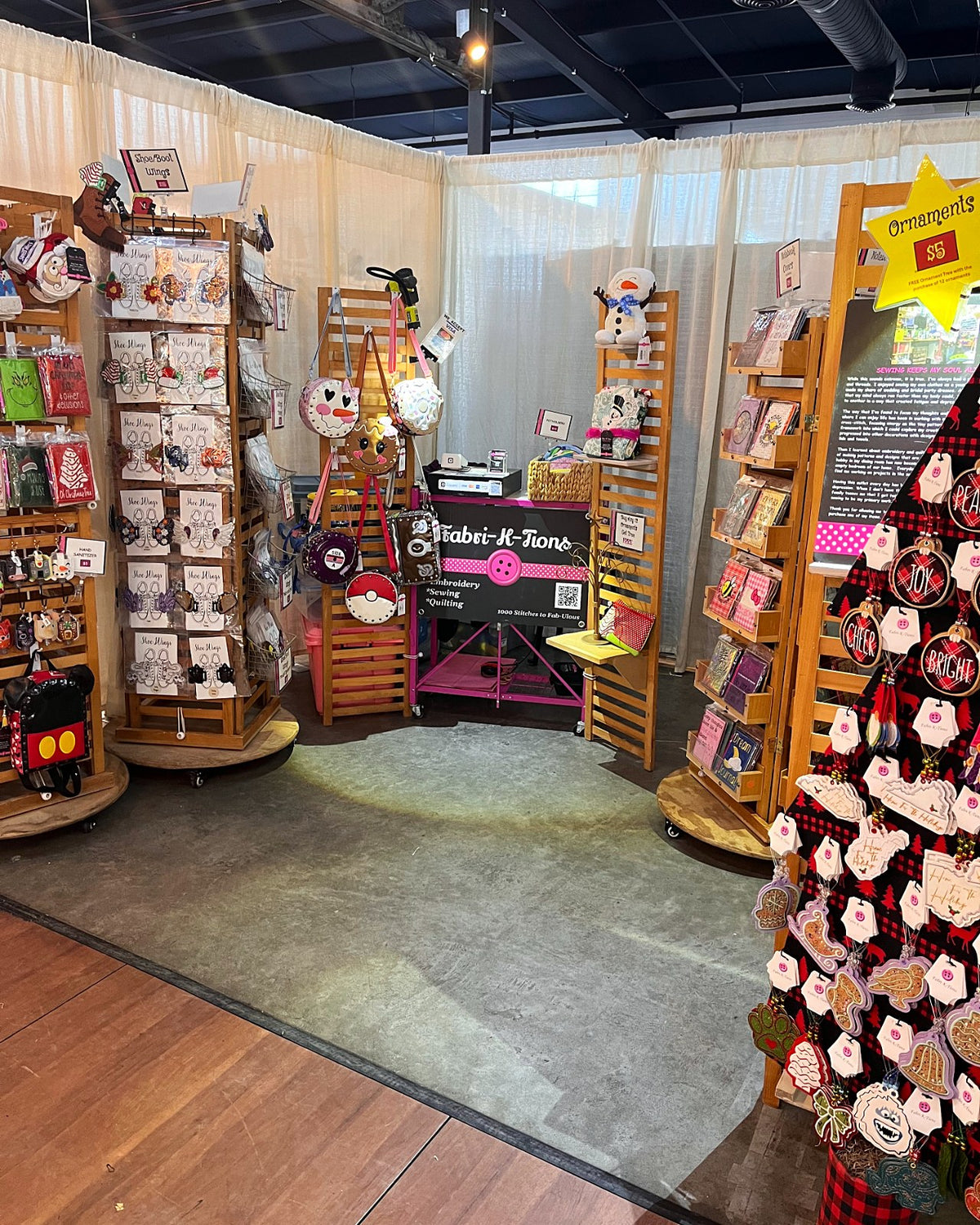Fabri-K-Tions holiday market booth with handmade ornaments, notebooks and dolls